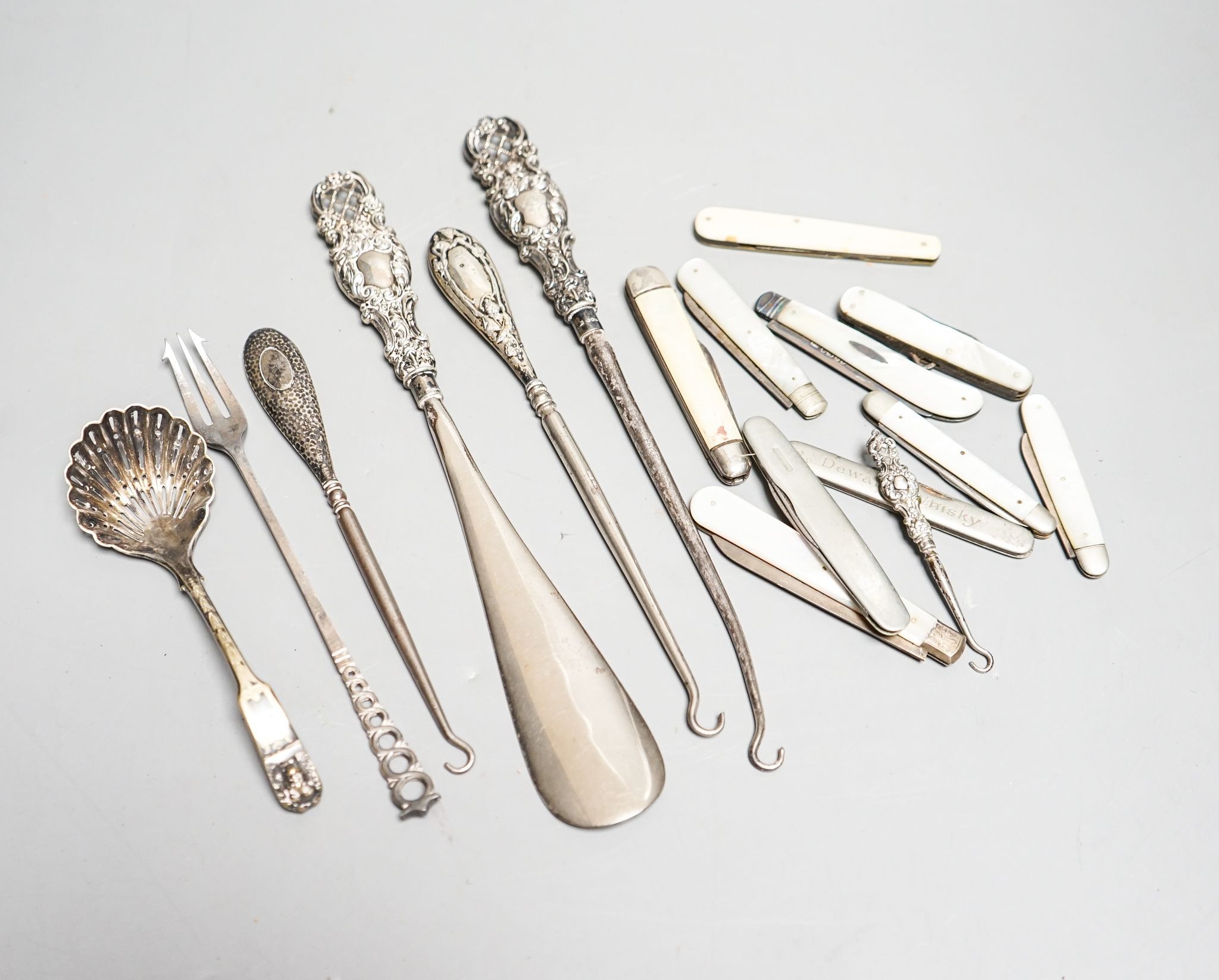 Eight various silver bladed fruit knives, three silver handled button hooks and silver handled shoe horn and button hook set